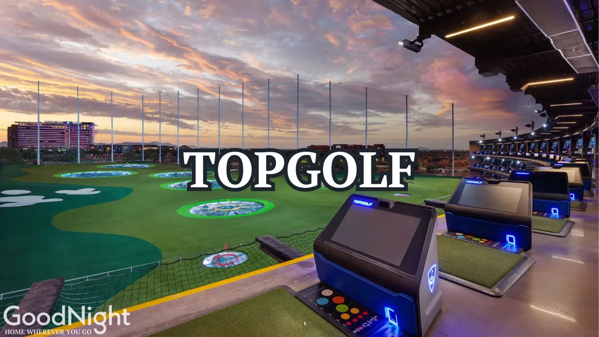 A dynamic view of Topgolf at sunset, showcasing bustling golf bays, colorful target greens, and a city skyline in the distance. People are seen playing, dining, and socializing under the stars.