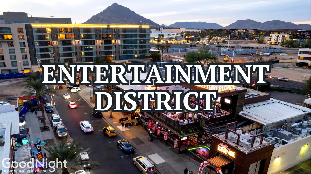 A vibrant scene featuring Scottsdale's Entertainment District with prominent signage, bustling street activity, colorful outdoor seating, and a backdrop of scenic mountains. The image captures groups of people engaging in nightlife and dining experiences.